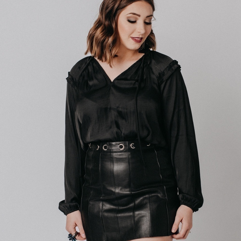Beautiful black silky peasant blouse. Cute ruffle detail on top with neck tie.